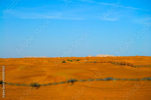 sand dunes in the desert with blurred fencing, UAE, AL Madaam, Dubai photo