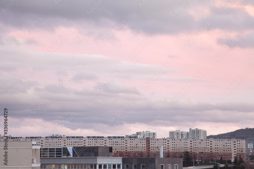 Beautiful, abstract view of the tops of the buildings in Clermont Ferrand in France and colorful, purple, cloudy sunset sky Beautiful, abstract view of the tops of the buildings in Clermont Ferrand in France and colorful, purple, cloudy sunset sky