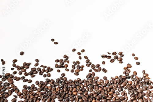 Shiny freshly roasted coffee beans on a white background. Isolated