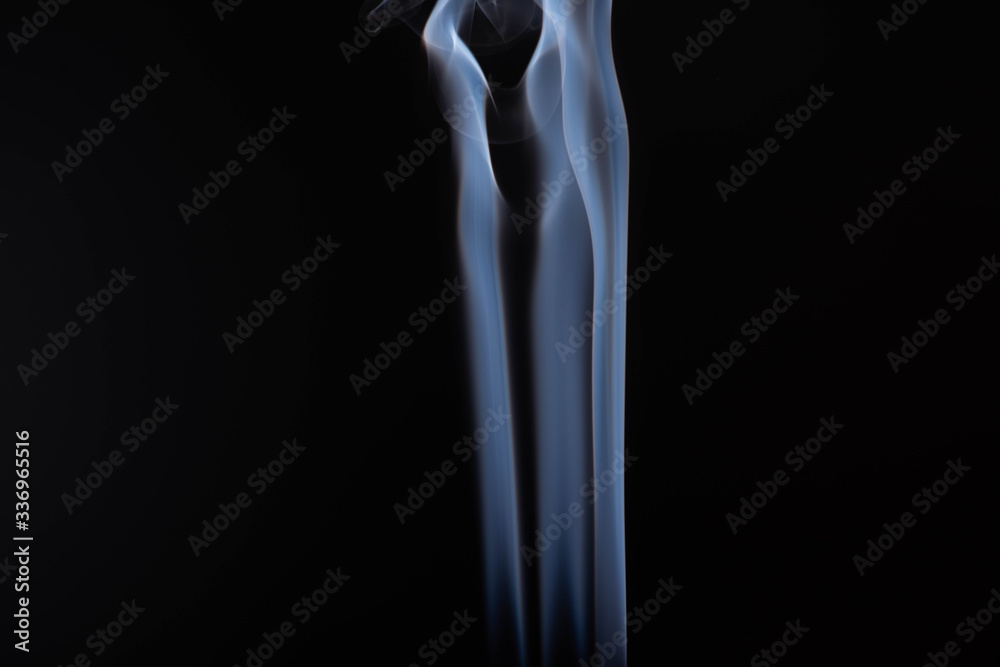 white flowing smoke steam on black background with copy space white flowing smoke steam on black background with copy space