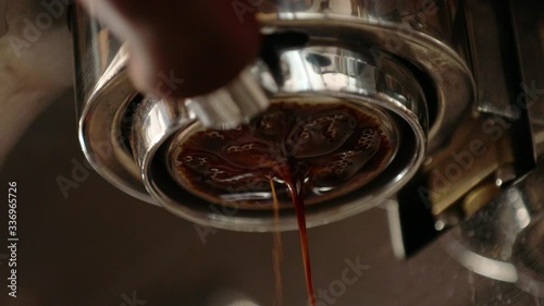 Advertising, business, beverage , lifestyle concept making fresh coffee going out from a coffee espresso machine. barista making coffee preparation service in coffee shop.