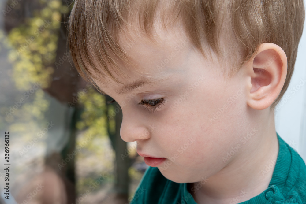 Close-up portrait of a three year old baby. sad side look Close-up portrait of a three year old baby. sad side look