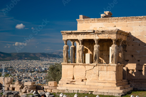 The Erechtheum temple stone porch with caryatids in Erechtheion in Acropolis, Athens in Greece with city view