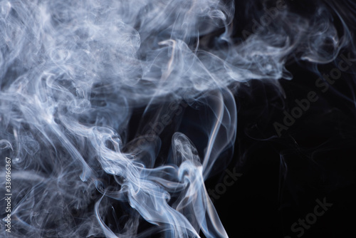 abstract white flowing smoke clouds on black background