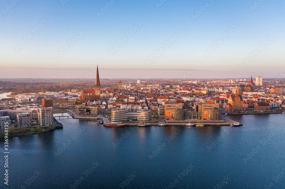 panorama of the city of rostock - aerial view over the river warnow, skyline during sunrise