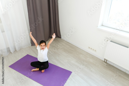 little girl practices yoga at home