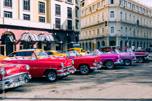 Vintage classic american car in Havana, Cuba. Typical Havana urban scene with colorful buildings and old cars.