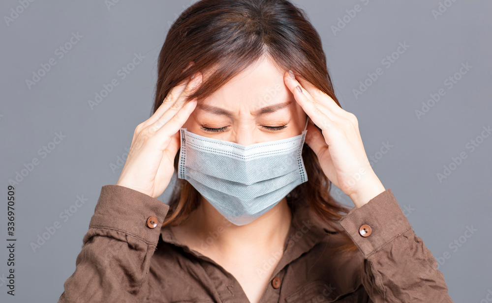 young woman wear medical mask with  headache  concepts