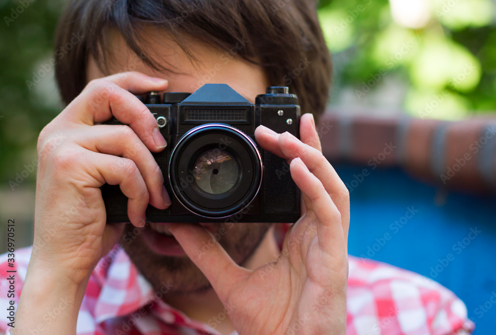 Man taking photos with old analog camera close-up Man taking photos with old analog camera close-up