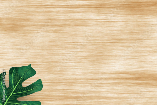 green leaves on wooden background