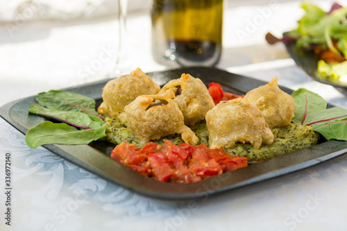 Cheff serving traditional Moroccan food on outdoor stand. photo