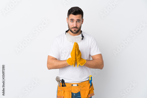 Craftsmen or electrician man over isolated white background pleading