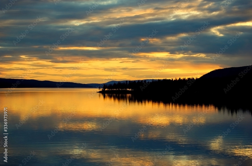 Fototapeta premium Orange sunset sky over the evening river