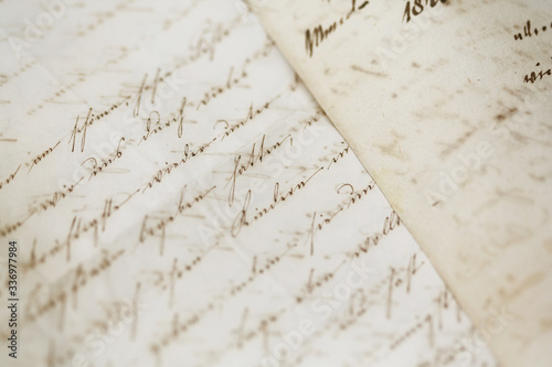 closeup of old handwriting; vintage paper background
