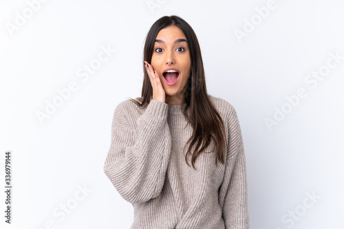 Young brunette woman over isolated white background with surprise and shocked facial expression