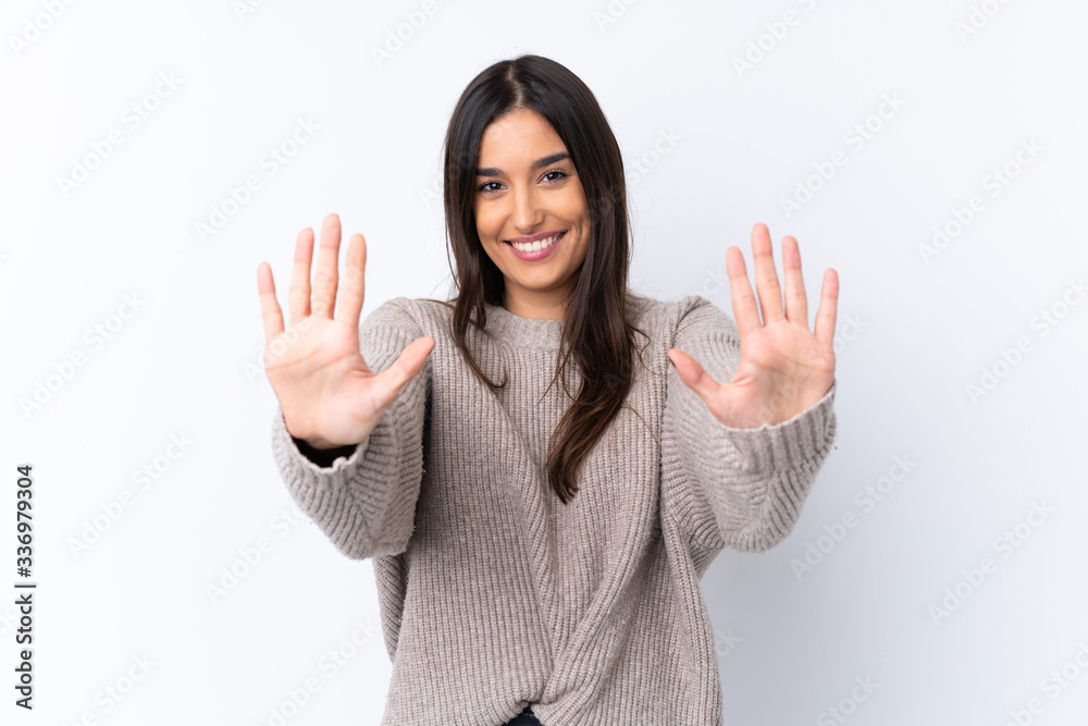 Young brunette woman over isolated white background counting ten with fingers Young brunette woman over isolated white background counting ten with fingers