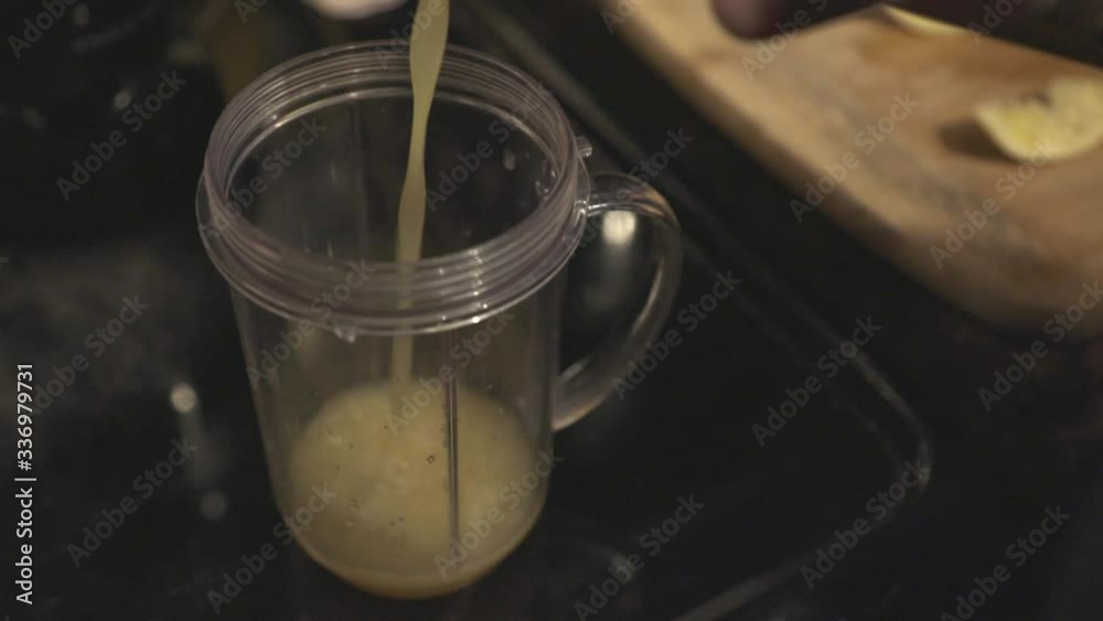 Pouring Pineapple Juice To A Clear Pitcher For Smoothie Making - Closeup Shot Pouring Pineapple Juice To A Clear Pitcher For Smoothie Making - Closeup Shot