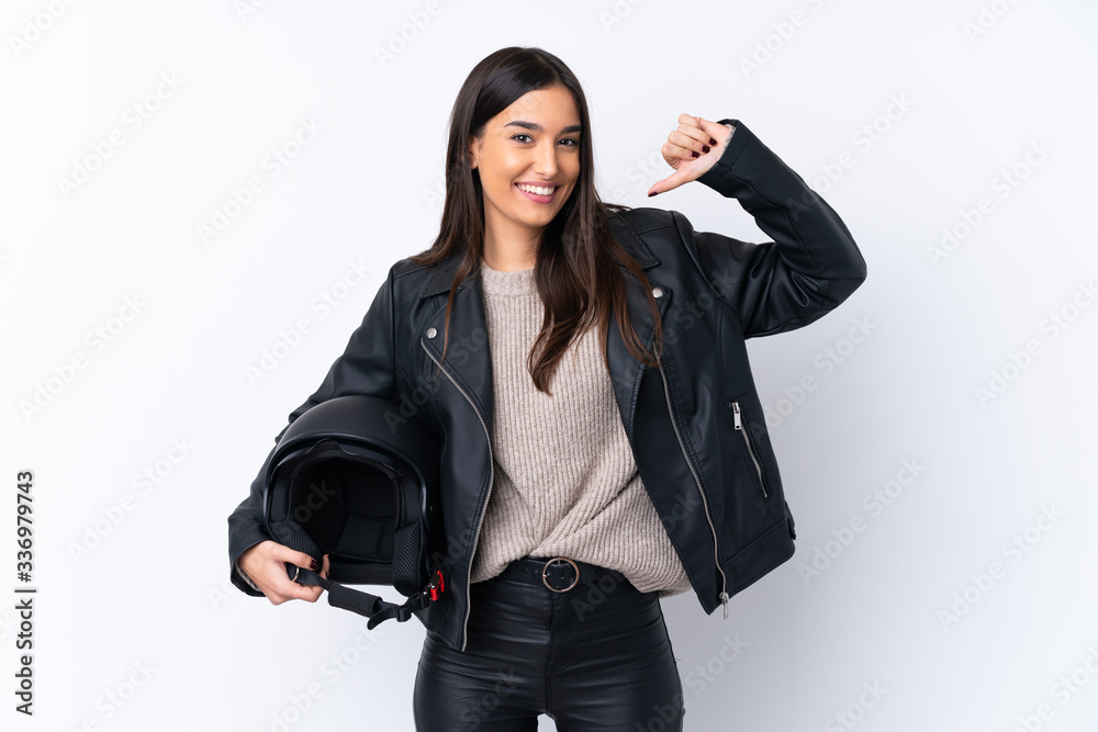 Young brunette woman with a motorcycle helmet over isolated white background proud and self-satisfied Young brunette woman with a motorcycle helmet over isolated white background proud and self-satisfied
