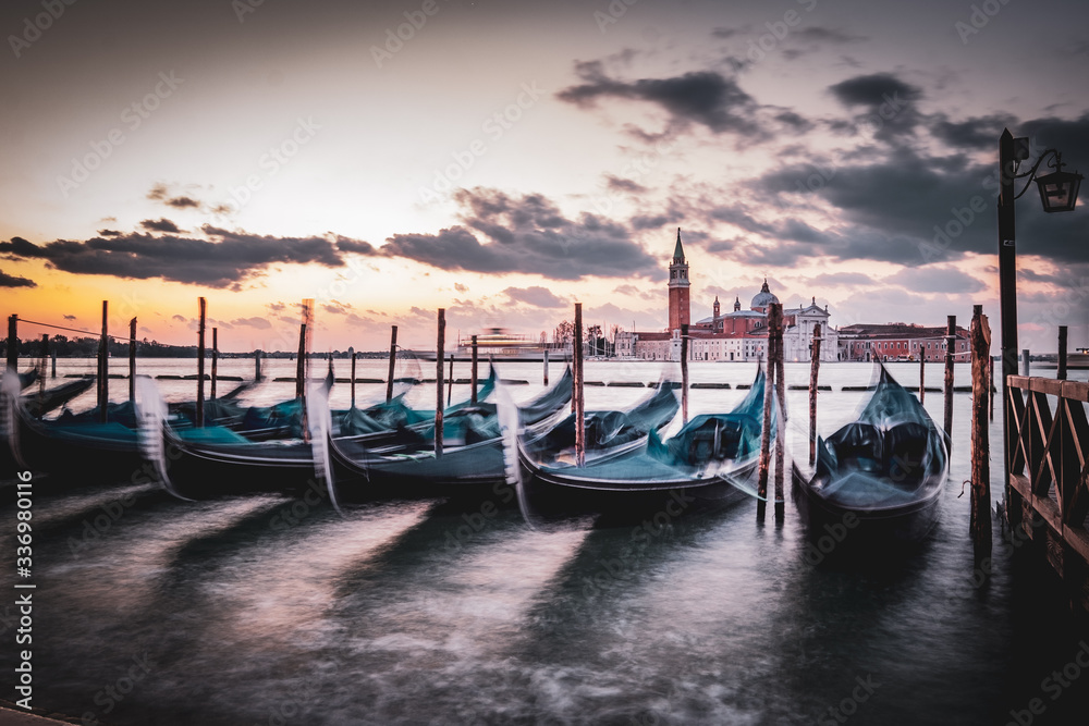 Sunrise in San Marco square with gondole service tourist people, Venice. Italy 
