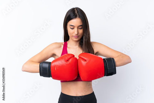 Young sport brunette woman over isolated white background with boxing gloves