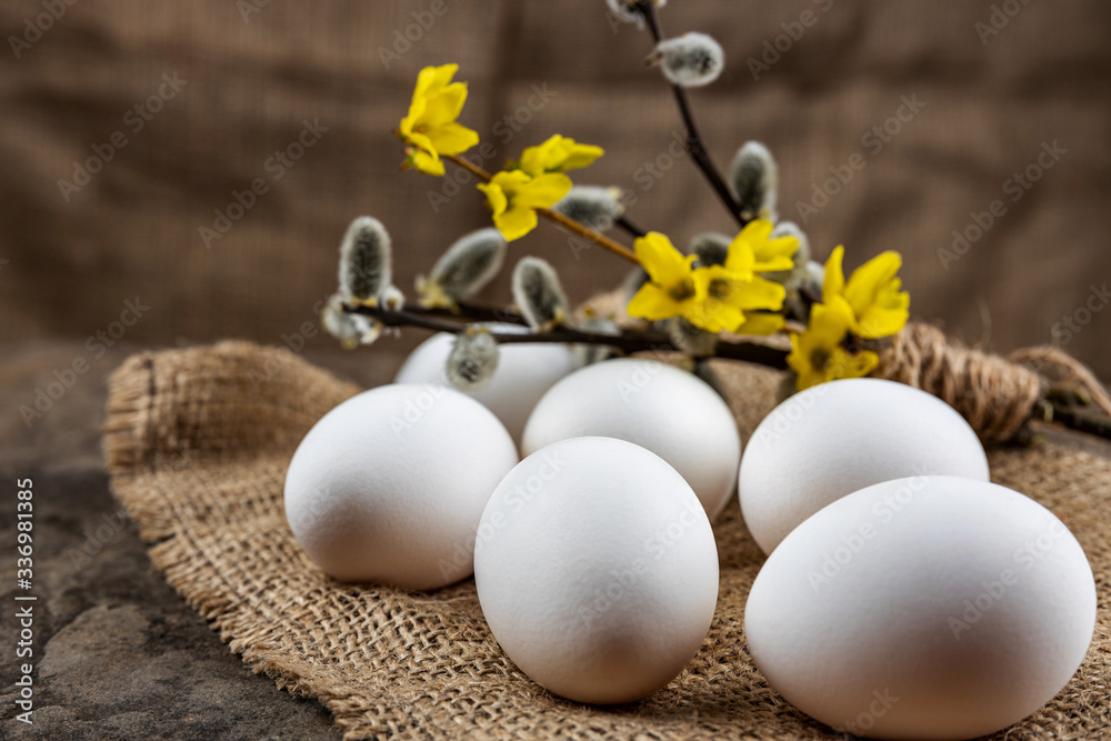 Fresh organic farm eggs lie on burlap, on a stone slab, close-up, selective focus, shallow depth of field. Concept, healthy food, spring religious holidays. Fresh organic farm eggs lie on burlap, on a stone slab, close-up, selective focus, shallow depth of field. Concept, healthy food, spring religious holidays.