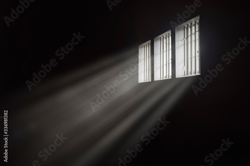 Fényképezés Beams of light through a barred prison cell window