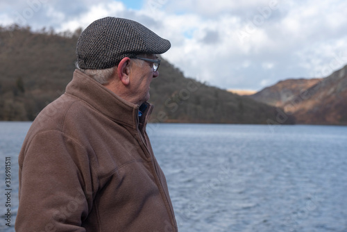 Mature man overlooking a lake, outdoors in Autumn
