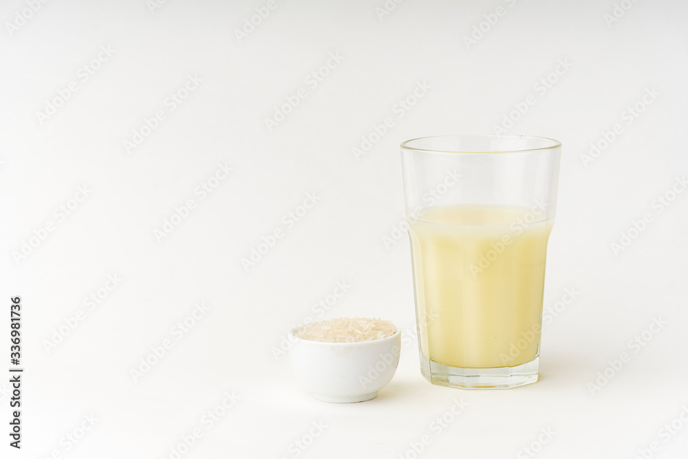 Dairy alternative. Rice milk in a high glass on white background. Dairy alternative. Rice milk in a high glass on white background.
