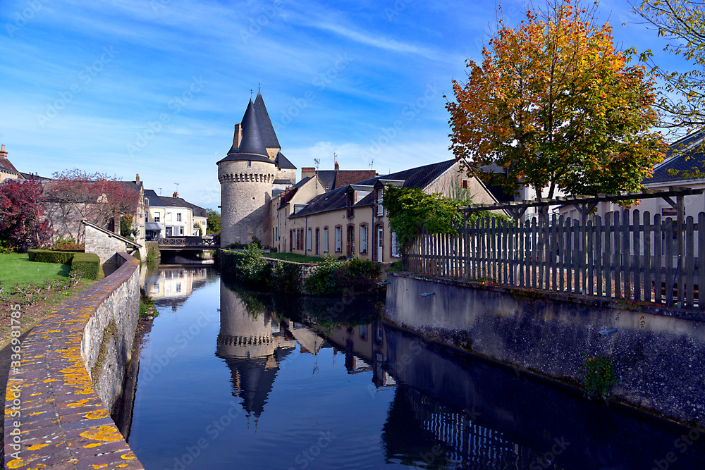 Keep of the fortified gate Saint-Julien on the Huisne river with big reflection at La-Ferté-Bernard, a commune in the Sarthe department in the Pays de la 	Loire region in north-western France.