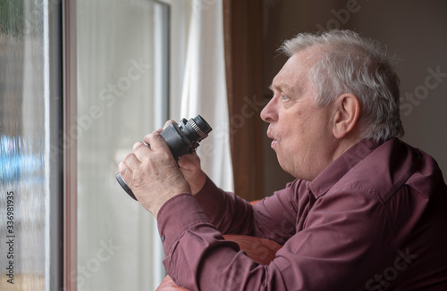 Nosy neighbor looking out of window with shocked expression, holding binoculars