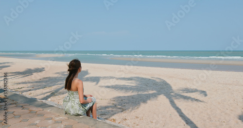 Woman sit at the sand beach