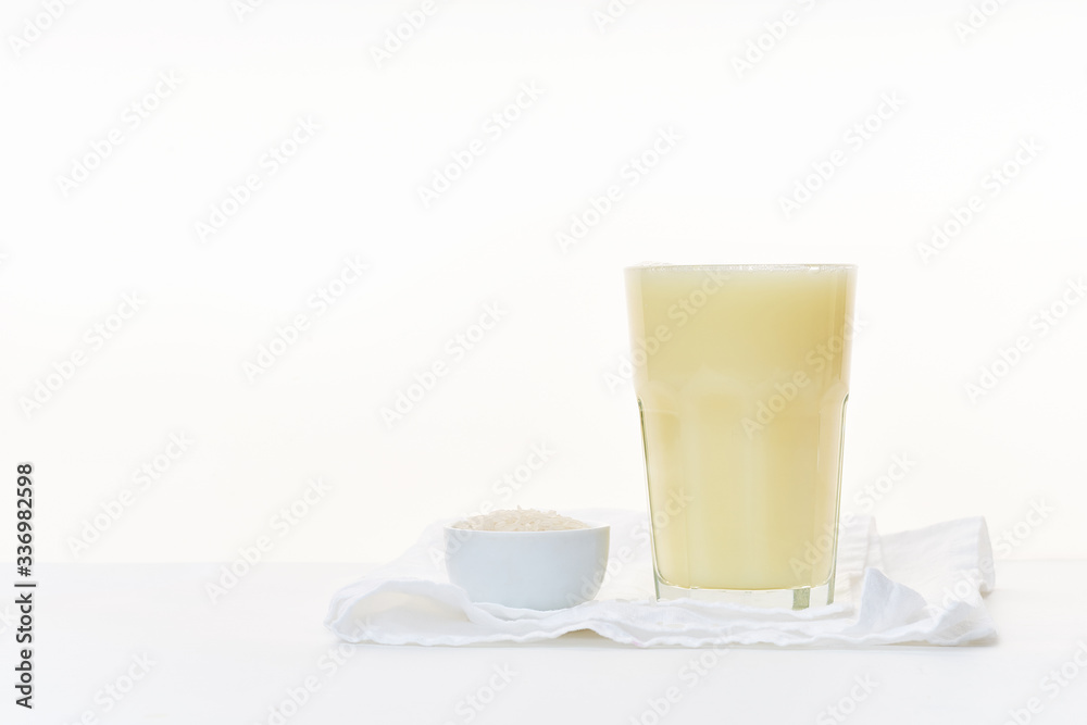 Dairy alternative. Rice milk in a high glass on white background. Dairy alternative. Rice milk in a high glass on white background.