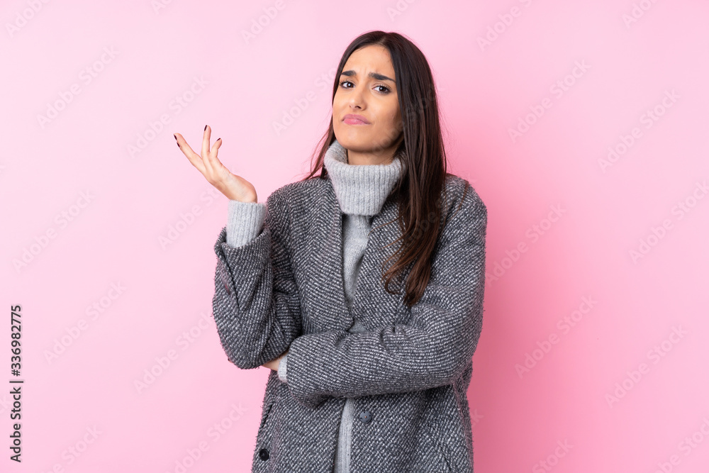 Young brunette woman over isolated pink background unhappy for not understand something Young brunette woman over isolated pink background unhappy for not understand something
