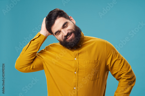 Cheerful bearded man smile yellow shirt studio emotion