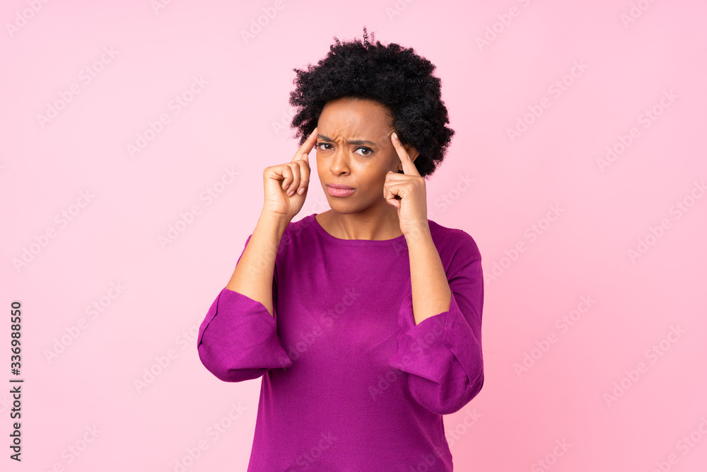 African american woman over isolated pink background having doubts and thinking African american woman over isolated pink background having doubts and thinking