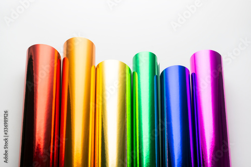 Bright shiny colorful foil in rolls on a white background