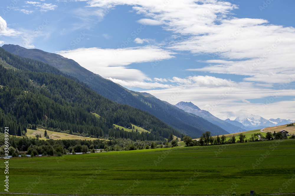 meadows at the foot of the Alpine mountains in switzerland