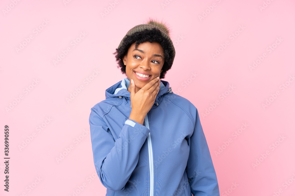 African american woman with winter hat over isolated pink background thinking an idea African american woman with winter hat over isolated pink background thinking an idea
