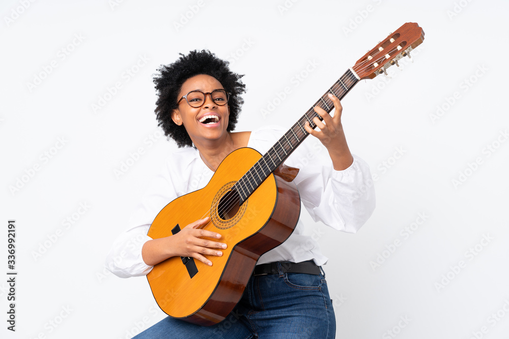 Fototapeta premium African american woman with guitar over isolated background