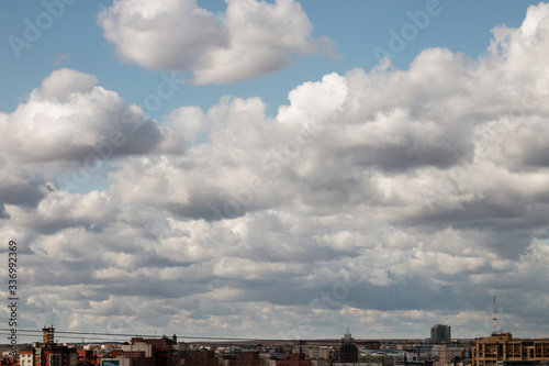 Blue sky background with large clouds over the city of Saransk. Blue sky with fluffy white clouds