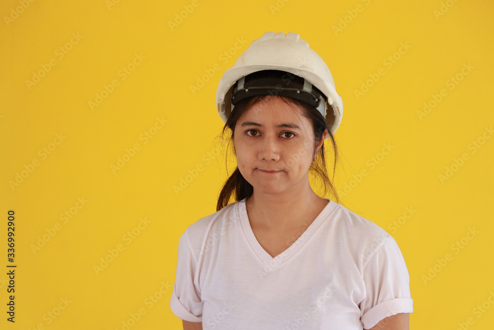 Female civil engineer with white helmet and wear white T-shirt on yellow background. Female civil engineer with white helmet and wear white T-shirt on yellow background.