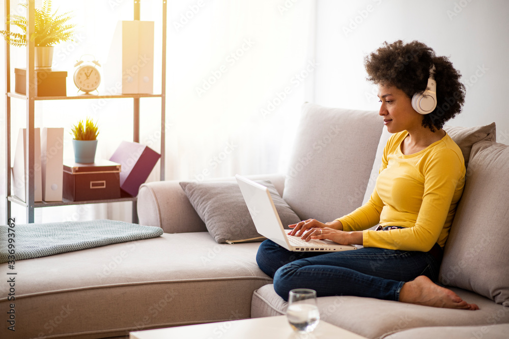 Woman working in isolation in home in a state of emergency. Woman working from home, using laptop in quarantine. Concept of female business and career, housekeeping, stress. Lifestyle moment. Woman working in isolation in home in a state of emergency. Woman working from home, using laptop in quarantine. Concept of female business and career, housekeeping, stress. Lifestyle moment.