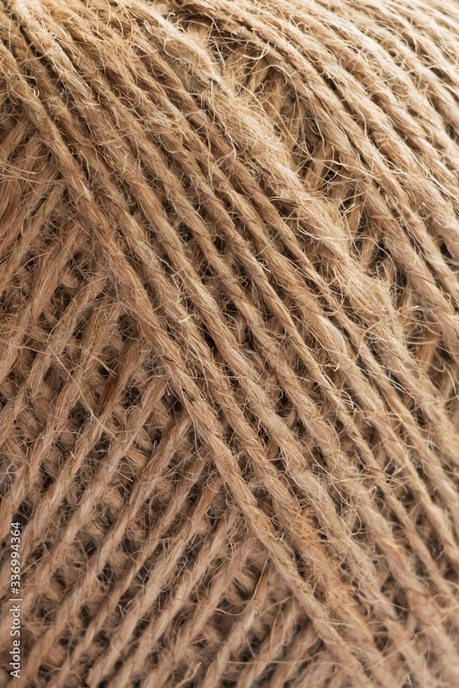 Natural jute ball of twine close-up. Supplies and tools for manual work hobby leisure. Rope in a skein close-up. Natural jute ball of twine close-up. Supplies and tools for manual work hobby leisure. Rope in a skein close-up.