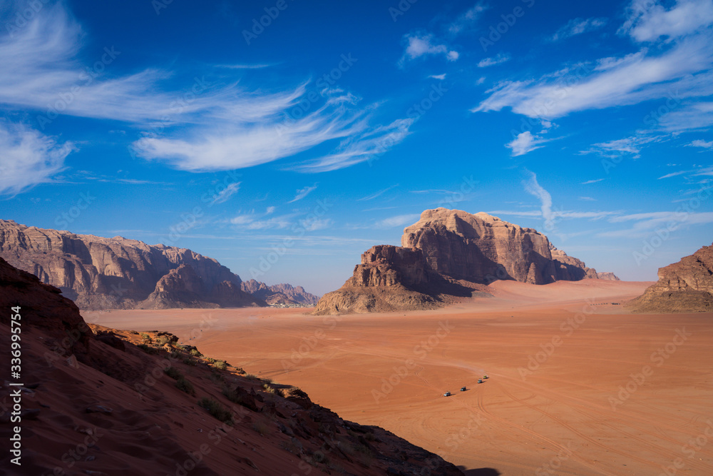 Naklejka premium Wadi rum desert with jeep caravan