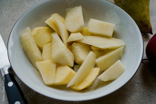 Sliced and peeled apples in a bowl