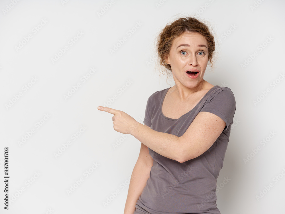 surprised young woman pointing at something surprised young woman pointing at something