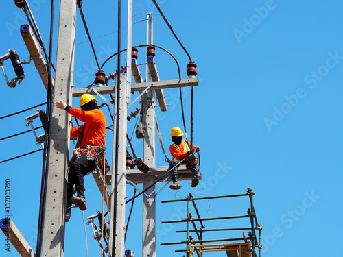 Man Working on the Working at height with blue sky at construction site