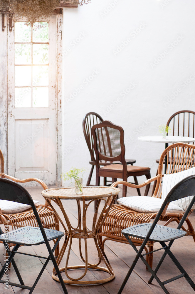 Interior living room vintage conception, rattan table and chair set in dinning room, classic house interior.