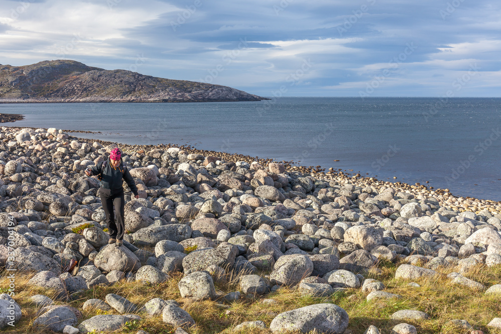 Tourists walking along the coast of the Barents Sea.