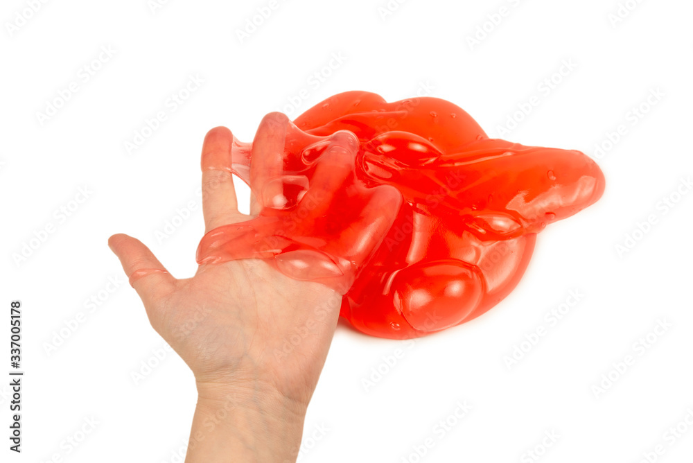 Red slime toy in woman hand isolated on white. Red slime toy in woman hand isolated on white.